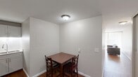 Located at 600 Martin Luther King Jr Blvd in Chapel Hill, NC, this one-bedroom, one-bathroom unit offers an efficient and well-organized single-floor layout. Warm hardwood flooring flows throughout the main living areas, creating a cohesive and inviting atmosphere.

The living room is a bright, open space highlighted by a wall of floor-to-ceiling windows with vertical blinds, allowing abundant natural light and views of the surrounding greenery. A charming exposed brick accent wall adds architectural character to the space.

The kitchen is efficiently designed and well-equipped, featuring stainless steel appliances including a full-size refrigerator, electric range with over-the-range microwave, and a sink with ample counter space. Gray cabinetry provides generous storage, and the hardwood flooring continues seamlessly from the living area.

The bedroom is a calm, understated retreat with neutral walls, built-in closet storage, and hardwood flooring, offering a quiet and functional space for rest.

The bathroom includes a full tub-shower combination with tiled surround, a toilet, and tile flooring, keeping with a clean and practical design.

Overall, this unit presents a straightforward and functional living space suited for those seeking a well-located home in Chapel Hill.