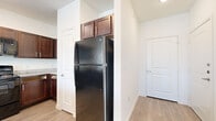 This single-story, 4-bedroom, 2-bathroom home in Austin, TX offers a well-designed layout suited for comfortable everyday living. The open-concept kitchen and living area serves as the heart of the home, featuring rich dark wood cabinetry, granite countertops, a black appliance suite including a refrigerator, range, and built-in microwave, and a peninsula with pendant lighting and a undermount sink — ideal for both cooking and casual dining. Light wood-look flooring flows throughout the main living areas, lending a clean, cohesive aesthetic. The living room is bright and airy, with multiple windows allowing natural light to fill the space, a ceiling fan, and a glass door leading to an outdoor area. The four bedrooms offer a mix of flooring — some with soft carpet and others with hard-surface floors — and each features ceiling fans and windows with outdoor views. The bedrooms provide generous space for furnishings and personal use, with the primary bedroom offering a dedicated closet. Both bathrooms are finished with dark wood vanities with brushed nickel hardware, white tile tub/shower surrounds, and light wood-look flooring, maintaining a consistent design throughout. This home combines functional layout with clean, modern finishes.
