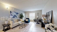 Located on Rodgers Avenue in Largo, FL, this single-story, one-bedroom, one-bathroom unit offers a practical and well-appointed layout across a compact but efficiently designed floor plan. Light-toned tile flooring runs throughout the main living areas, contributing to a bright and cohesive aesthetic.

The open-concept living and dining area is anchored by large windows with vertical blinds, allowing abundant natural light to fill the space. A textured ceiling adds character overhead, while neutral gray walls provide a versatile backdrop throughout. The living area flows seamlessly into the dining space, creating an inviting zone for both relaxing and entertaining.

The galley-style kitchen is thoughtfully designed with gray shaker-style cabinetry, white quartz countertops, a stainless steel undermount sink, and a full suite of stainless steel appliances including a range, microwave, dishwasher, and refrigerator. A pass-through counter connects the kitchen to the living area, enhancing the open feel.

The bedroom is generously proportioned, featuring wood-look flooring, a sliding door closet, and a large window alongside a glass door providing direct access to the outdoors. The bathroom includes a full tub-shower combination, a vanity with quartz countertops, and tile flooring.

A screened patio off the unit offers peaceful views of the surrounding green lawn and mature trees, ideal for enjoying Florida's outdoor lifestyle.