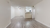 Located at 825 South Hobart Boulevard in Los Angeles' Koreatown neighborhood, this single-floor, 2-bedroom, 2-bathroom residence offers a thoughtfully laid-out living space with a clean, bright aesthetic throughout. The living room serves as the heart of the home, featuring wood-look laminate flooring, a classic fireplace, built-in shelving, and a large window that invites natural light. A ceiling fan adds comfort to the open feel of the space. The pass-through kitchen connects seamlessly to the living area and is equipped with white cabinetry, granite-style countertops, and stainless steel appliances, offering both functionality and style. Both bedrooms are well-proportioned, featuring the same wood-look flooring, neutral walls, textured ceilings, and windows with vertical blinds that allow for natural light and privacy. Each room includes dedicated closet space. The two bathrooms are finished with white vanity cabinetry, granite-style countertops, updated mirrors, and wood-look flooring consistent with the rest of the unit. One bathroom features a tub-shower combination with glass sliding doors. The uniform flooring, neutral color palette, and consistent finishes throughout create a cohesive and move-in ready living environment.