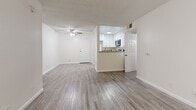 Located at 825 South Hobart Boulevard in Los Angeles' Koreatown neighborhood, this single-floor, 2-bedroom, 2-bathroom residence offers a thoughtfully laid-out living space with a clean, bright aesthetic throughout. The living room serves as the heart of the home, featuring wood-look laminate flooring, a classic fireplace, built-in shelving, and a large window that invites natural light. A ceiling fan adds comfort to the open feel of the space. The pass-through kitchen connects seamlessly to the living area and is equipped with white cabinetry, granite-style countertops, and stainless steel appliances, offering both functionality and style. Both bedrooms are well-proportioned, featuring the same wood-look flooring, neutral walls, textured ceilings, and windows with vertical blinds that allow for natural light and privacy. Each room includes dedicated closet space. The two bathrooms are finished with white vanity cabinetry, granite-style countertops, updated mirrors, and wood-look flooring consistent with the rest of the unit. One bathroom features a tub-shower combination with glass sliding doors. The uniform flooring, neutral color palette, and consistent finishes throughout create a cohesive and move-in ready living environment.