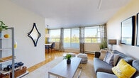 Located at 1071 Ambleside Drive in Ottawa's Ambleside neighbourhood, this one-bedroom, one-bathroom unit offers a well-organized layout across a single floor. The living room is generously proportioned, showcasing classic parquet hardwood flooring, warm neutral tones, and large floor-to-ceiling windows that flood the space with natural light and offer pleasant treetop views. The adjoining dining area continues the parquet flooring and benefits from its own window, making it a bright spot for everyday meals. The galley-style kitchen features tile flooring, ample upper and lower cabinetry with wood-trim detailing, a tile backsplash, and full-sized appliances including a refrigerator, stove, and built-in range hood. The bedroom is a comfortable retreat, complete with parquet hardwood floors, a large window dressed with navy curtains framing outdoor greenery, a sliding-door closet, and warm accent wall tones. The bathroom includes a vanity with under-sink storage, a large mirror, and classic tile flooring. Throughout the unit, the consistent warm colour palette and natural light create a cohesive, inviting ambiance suited for comfortable everyday living.
