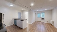 Located at 4540 MacArthur Blvd NW in Washington, DC, Unit 16 is a well-appointed one-bedroom, one-bathroom residence that makes efficient use of its compact footprint. Throughout the unit, warm-toned hardwood-style flooring and crisp white walls create a clean, cohesive aesthetic, complemented by classic crown molding that adds a touch of traditional character.

The kitchen is thoughtfully designed with white shaker-style cabinetry, dark granite countertops, and a full suite of stainless steel appliances, including an electric range, over-the-range microwave, refrigerator, and dishwasher. The galley-style layout maximizes storage and counter space, making it highly functional for everyday cooking.

The bedroom is a comfortable, well-proportioned room featuring two side-by-side closets that provide ample storage. A classic cast-iron radiator and a window allow for natural light and ventilation, adding to the room's charm.

The bathroom is finished in bright white tile flooring and features a full tub-shower combination, offering a clean and practical design.

The unit's layout flows naturally from room to room, making it an efficient and comfortable living space. Its location in the desirable Georgetown/Palisades neighborhood of Northwest DC places it near parks, dining, and transit options.