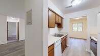 Located at 581 Lake Forest Ln in Norton Shores, Michigan, this single-story, one-bedroom, one-bathroom residence offers a practical and comfortable layout across a thoughtfully designed floor plan. The space is organized to maximize functionality, with distinct areas for living, sleeping, cooking, and storage.

The galley-style kitchen is a standout feature, equipped with warm wood cabinetry, light countertops, a double-basin sink, a dishwasher, an electric range, and a full-size refrigerator. Light-toned, hardwood-style flooring runs through the kitchen and connects seamlessly to the living area, creating a cohesive and easy-to-maintain surface throughout the main living spaces.

The living room offers an open, neutral canvas with clean white walls and the same durable hardwood-style flooring, providing a bright and versatile space. A hallway connects the main living area to the private quarters of the home.

The bedroom is generously proportioned, finished with plush carpet for added comfort, and features a dedicated closet with built-in shelving. A window allows natural light to fill the room, creating a welcoming atmosphere. The full bathroom includes a tiled tub-shower combination with assistive grab bars, a toilet, and a vanity, all finished in clean, neutral tones.