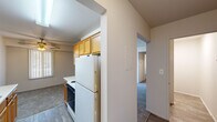 Located at 11501 Dorchester St in Southgate, Michigan, this single-floor unit offers a functional and well-organized layout across two bedrooms, one full bathroom, a kitchen, and three hallways that connect the living spaces efficiently. The galley-style kitchen features warm oak cabinetry on both sides, white laminate countertops, a stainless steel sink, and white appliances including an electric range and refrigerator, all set atop wood-look vinyl flooring. The spacious primary bedroom includes a built-in closet with shelving and a window fitted with vertical blinds that allow natural light to filter in. The second bedroom is similarly appointed with plush carpeting, a window with vertical blinds, and closet access. Both bedrooms maintain a neutral color palette with clean white walls. The full bathroom includes a tub and shower combo with light tile surround, a single-sink vanity with oak cabinetry, and wood-look flooring. Hallways connect each room with ease, and a dedicated closet provides additional storage. The unit offers a straightforward, practical living environment suited for comfortable everyday use.