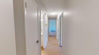 Located at 742 Kingsmere Crescent Southwest in Calgary's Kingsland neighbourhood, this two-bedroom, one-bathroom unit offers a practical and well-organized single-floor layout. Light wood-tone flooring runs throughout, creating a cohesive and bright feel across all rooms. A central hallway connects the key areas of the unit, with textured ceilings adding a classic touch overhead.

The primary bedroom is a comfortable size, featuring a full-width mirrored sliding closet that reflects light and enhances the sense of space. The second bedroom is equally well-appointed with its own mirrored sliding closet and a window that overlooks the surrounding neighbourhood and mature trees, allowing natural light to fill the room. Both bedrooms are equipped with baseboard heating for year-round comfort.

The bathroom is clean and efficiently designed, featuring a full tub-shower combination with white subway tile surround, a floating vanity with a grey countertop, and wood-tone flooring that ties into the rest of the unit. An overhead ventilation fan ensures proper airflow.

The layout, as seen in the 3D model, makes efficient use of the available space, with rooms positioned to maximize functionality. The unit's neutral colour palette, light flooring, and consistent finishes throughout create a calm, move-in-ready environment suited for a variety of lifestyles.