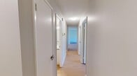 Located at 742 Kingsmere Crescent Southwest in Calgary's Kingsland neighbourhood, this two-bedroom, one-bathroom unit offers a practical and well-organized single-floor layout. Light wood-tone flooring runs throughout, creating a cohesive and bright feel across all rooms. A central hallway connects the key areas of the unit, with textured ceilings adding a classic touch overhead.

The primary bedroom is a comfortable size, featuring a full-width mirrored sliding closet that reflects light and enhances the sense of space. The second bedroom is equally well-appointed with its own mirrored sliding closet and a window that overlooks the surrounding neighbourhood and mature trees, allowing natural light to fill the room. Both bedrooms are equipped with baseboard heating for year-round comfort.

The bathroom is clean and efficiently designed, featuring a full tub-shower combination with white subway tile surround, a floating vanity with a grey countertop, and wood-tone flooring that ties into the rest of the unit. An overhead ventilation fan ensures proper airflow.

The layout, as seen in the 3D model, makes efficient use of the available space, with rooms positioned to maximize functionality. The unit's neutral colour palette, light flooring, and consistent finishes throughout create a calm, move-in-ready environment suited for a variety of lifestyles.
