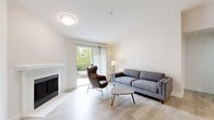 Located in Everett, WA, this single-floor unit at 2508 113th St SE, E333, offers a thoughtfully designed living space with a clean, modern aesthetic throughout. The living room serves as the heart of the home, featuring light wood-style flooring, a classic white-mantled fireplace, and a sliding glass door that opens to a private balcony with peaceful views of lush evergreen trees. Natural light flows generously into the space, enhancing its bright and airy feel.

The galley-style kitchen is well-appointed with white shaker cabinetry, quartz countertops, a subway tile backsplash, a stainless steel undermount sink, and a full suite of stainless steel appliances including a refrigerator, electric range, microwave, and dishwasher. Light wood flooring continues throughout, maintaining a cohesive look across the unit.

The primary bedroom offers a comfortable layout with a walk-in closet, while the secondary bedroom includes a sliding-door closet and similarly neutral finishes. The bathroom is clean and functional, featuring a white vanity with quartz countertop, a tub/shower combo, and wood-look tile flooring. An in-unit washer and dryer are conveniently located nearby, adding to the overall practicality of this well-maintained home.