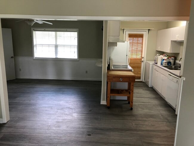 View of the kitchen and part of the dining room from the living room. - 405 Palmwood Dr