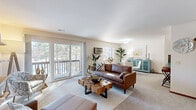 Located at 1874 RW Berends Dr SW in Wyoming, Michigan, this single-floor, 2-bedroom, 1-bathroom unit offers a practical and comfortable layout. The living room serves as the heart of the space, featuring neutral carpet flooring, large sliding glass doors that open onto a private balcony, and a wall-mounted AC unit. Natural light flows freely through the expansive glazing, offering pleasant outdoor views of surrounding trees.

The kitchen is equipped with warm oak cabinetry extending to the ceiling, a dark stone-style laminate backsplash and countertops, a double stainless steel sink, a black dishwasher, and a gas range, all set on tile flooring. A hallway connects the main living areas to both bedrooms and the shared bathroom.

The primary bedroom is a well-proportioned, carpeted room with a window admitting natural light and a double-door closet. The second bedroom is similarly carpeted, with its own closet and window. Both rooms offer a quiet, understated atmosphere.

The bathroom features tile flooring, an oak vanity with a stone-style countertop, a large mirror, and a shower-tub combination. Overall, the space maintains a clean, functional character throughout.