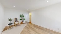 Located at 2301 W La Habra Blvd in La Habra, CA, this single-story, one-bedroom, one-bathroom unit offers a clean, modern aesthetic throughout its thoughtfully arranged floor plan. Light wood-look flooring flows seamlessly across every room, complemented by crisp white walls and bright recessed lighting that lend an airy, cohesive feel to the space.

The living room is generously proportioned, featuring a ceiling fan with lighting and a large window dressed with vertical blinds, inviting natural light and outdoor views. Adjacent to the living area, the dining space accommodates a full dining table and benefits from its own window overlooking greenery outside.

The galley-style kitchen is a standout feature, outfitted with white shaker cabinetry, matte black hardware, white quartz countertops, a classic subway tile backsplash, stainless steel appliances, and a deep single-basin sink — combining style with practical functionality.

The spacious primary bedroom includes recessed lighting, a wall heater, and access to a dedicated walk-in closet. The bathroom is clean and contemporary, featuring a full tub-shower combo, a white vanity with ample drawer storage and matte black hardware, and a window for natural ventilation. A connecting hallway ties all rooms together efficiently, completing this well-designed unit.