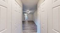 Located at 200 W 75th Pl in Merrillville, Indiana, this single-floor, 3-bedroom, 1-bathroom home offers a practical and comfortable layout with thoughtfully updated finishes throughout. The main living area features durable wood-look plank flooring and a ceiling fan with light fixture, creating a bright and functional space. Natural light filters in through windows fitted with blinds, offering views of the surrounding greenery.

The kitchen has been updated with gray shaker-style cabinetry, light granite-look countertops, a double-basin sink, and stainless steel appliances including a refrigerator, electric range with over-the-range ventilation, and dishwasher. The wood-look flooring continues seamlessly into this space, contributing to a cohesive aesthetic.

The spacious primary bedroom is notably generous in size and features hardwood-style flooring, a ceiling fan, and a large double-door closet. The two additional bedrooms are carpeted, each with closet storage and windows that bring in natural light. One bedroom includes a wall-mounted air conditioning unit alongside baseboard heating.

The full bathroom is finished with wood-look flooring, a combined tub-shower unit, a vanity with a stone-look countertop, and brushed gold hardware accents. Neutral wall tones and clean white trim are consistent throughout the home, lending a fresh and move-in-ready appearance.