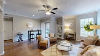 This 1-bedroom, 1-bathroom residence offers a comfortable and thoughtfully designed layout across a single floor. The open-concept living and dining area is a standout feature, showcasing warm hardwood-style flooring, crown molding, and a ceiling fan with light fixture. Built-in shelving adds both function and character, while a sliding glass door opens to an outdoor balcony, filling the space with natural light and providing exterior views. The kitchen is well-equipped with rich dark-wood cabinetry, granite countertops, a tile backsplash, and stainless steel appliances, including a range, microwave, and refrigerator. The bedroom is a serene retreat with plush carpet flooring, crown molding, a ceiling fan, and large windows that invite generous natural light. The full bathroom features dark wood vanity cabinetry, a marble-style countertop, tile flooring, a lighted vanity mirror, and a shower-tub combination. Additional spaces include a dedicated closet, a utility room, and a hallway that connects the layout efficiently. The neutral color palette and classic architectural details throughout create a cohesive and inviting ambiance.
