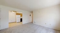 Located at 407 S Fifth St in Ames, Iowa, this compact 2-bedroom, 1-bathroom apartment offers 500 square feet of efficiently arranged single-floor living. The unit features a straightforward layout connecting the kitchen, living area, bedrooms, and bathroom in a practical arrangement.

The kitchen is equipped with warm oak cabinetry offering ample storage, a white refrigerator, an electric range, and a built-in range hood. Light ceramic tile flooring extends through the kitchen and entry area, and a ceiling fan with light fixture provides overhead comfort. Baseboard heating runs throughout the unit for consistent warmth.

The spacious primary bedroom measures 190 square feet and features large windows that invite natural light and views of surrounding greenery. It includes a wall-mounted air conditioning unit, baseboard heating, and carpeted flooring. The second bedroom is similarly carpeted and includes a ceiling fan, a window, and baseboard heating, offering a comfortable and well-lit space.

The full bathroom features ceramic tile flooring, a wood vanity with storage, and a tiled shower-tub combination equipped with grab bars for added accessibility.

The unit's clean, neutral color palette throughout creates a bright and functional living environment well-suited for those seeking practical accommodations in Ames.