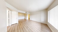 This well-organized two-bedroom, two-bathroom residence in North Las Vegas offers a practical and comfortable single-floor layout. The living room welcomes you with light wood-style vinyl flooring, neutral white walls, and a large window dressed with vertical blinds that fill the space with natural light. The kitchen is efficiently designed in a galley style, featuring white cabinetry with ample upper and lower storage, a double-basin sink, laminate countertops, and white appliances including a gas range and refrigerator. The kitchen opens seamlessly toward the living area, enhancing the sense of connectivity throughout the home. Both bedrooms are carpeted in warm beige tones and receive natural light through windows with vertical blinds. The primary bedroom includes a closet, offering practical storage. Each bathroom is clean and functional, featuring a tub-shower combo, toilet, and wood-style flooring that coordinates with the main living areas. A dedicated closet provides additional storage. The overall aesthetic is clean and neutral, with crisp white walls and consistent finishes throughout, creating a bright and move-in-ready atmosphere suited for comfortable everyday living.