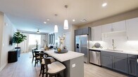 Located at 1501 Expo Pkwy in Sacramento, CA, this well-appointed 2-bedroom, 2-bathroom residence offers a thoughtfully designed single-level layout. The open-concept living area seamlessly connects the kitchen, dining, and living spaces, creating an inviting and functional environment. The kitchen is outfitted with two-tone gray and white cabinetry, stainless steel appliances including a French door refrigerator and dishwasher, quartz countertops, a central island with bar seating, and stylish pendant lighting. Light wood-look flooring flows throughout the main living areas, enhancing the bright and airy atmosphere. The living room features a ceiling fan and natural light from large windows. Both bedrooms are carpeted and generously sized, with the primary bedroom offering ample space and a dedicated closet. The two full bathrooms are finished with light wood-look flooring, white cabinetry, and tub/shower combinations. Additional highlights include three closets for abundant storage, an in-unit laundry area, and a private balcony. With its modern finishes and practical layout, this residence provides a comfortable and stylish living experience in Sacramento.