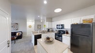 Located in Bixby, Oklahoma, this single-floor residence offers three bedrooms and three bathrooms within a thoughtfully designed layout. The open-concept kitchen serves as the heart of the home, showcasing white cabinetry, subway tile backsplash, granite countertops, a center island, and black appliances including a range, microwave, dishwasher, and refrigerator. Tile flooring in the kitchen transitions seamlessly into the carpeted living and dining areas. The living room is bright and welcoming, with natural light streaming in through large windows and a glass door, ceiling fan overhead, and comfortable proportions for everyday living. A dedicated dining area sits adjacent to the main living space, providing a natural flow for entertaining. Each of the three bedrooms features carpet flooring and ceiling fans, offering a calm and restful atmosphere. The bedrooms are served by three full bathrooms, each appointed with granite-top vanities, white cabinetry, tile flooring, and tub-shower combinations. A dedicated laundry area is accessible directly from the kitchen, adding everyday convenience. Neutral tones and clean finishes are carried throughout the home, creating a cohesive and move-in-ready environment.