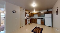Located at 5757 Will Ruth Ave in El Paso, Texas, this single-floor home offers a practical and comfortable layout designed for everyday living. The kitchen is well-equipped with rich wood cabinetry, white appliances including a gas range, microwave, dishwasher, and refrigerator, complemented by dark countertops and easy-to-clean tile flooring. Ample cabinet storage and a double-basin sink make this a highly functional space for cooking and meal preparation.

The living area is generously sized and features plush carpeting, a ceiling fan with light fixture, and a large sliding glass door that opens to an outdoor balcony, allowing abundant natural light and views of the surrounding greenery.

The bedrooms are comfortable and carpeted, each featuring windows with blinds that bring in natural light while maintaining privacy. One bedroom includes a ceiling fan, adding to the overall comfort of the space.

The bathroom is clean and well-appointed, featuring tile flooring, a vanity with granite-style countertop, a tub and shower combination, and a window for natural ventilation. Throughout the home, neutral wall tones and consistent finishes create a cohesive, move-in-ready atmosphere ideal for a variety of lifestyles.