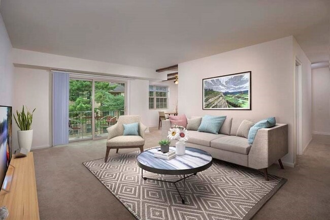 Spacious living area with large balcony at Deerfield Run & Village Square North Apartments - Deerfield Run & Village Square North Apartments