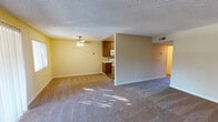 Located at 9585 Gold Coast Dr in San Diego, this single-floor unit offers a practical and comfortable layout designed for everyday living. The open living area is generously sized, featuring wall-to-wall carpeting, warm neutral-toned walls, a textured ceiling, and a ceiling fan that adds both comfort and character. Large sliding glass doors lead to a private balcony, allowing natural light to fill the space while offering outdoor views.

The galley-style kitchen is efficiently laid out, featuring rich wood cabinetry, light stone-patterned countertops, a stainless steel sink, and white appliances including a range, microwave, refrigerator, and dishwasher. Wood-look flooring runs throughout the kitchen, complementing the warm cabinetry tones.

The bedrooms are carpeted and well-proportioned, with neutral walls and windows that bring in natural light. The unit includes two bathrooms — one featuring a tub-shower combination with tile flooring and a wood-accented vanity, and a second with a glass-enclosed shower, tile flooring, and adequate storage. Throughout the unit, clean white baseboards and consistent neutral finishes contribute to a cohesive, move-in-ready atmosphere well-suited for comfortable San Diego living.