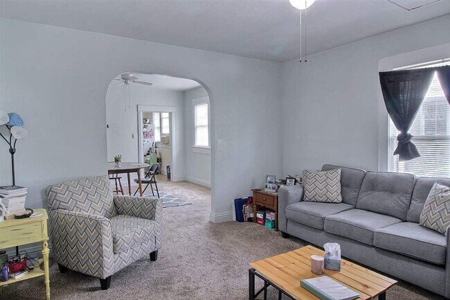 Unit 1 - Charming living room with view of dining. - 103 W 7th Ave