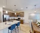 This contemporary two-story residence in Seagoville, Texas, offers 1,570 square feet of thoughtfully designed living space. The home features two bedrooms, including a generous 190 square foot primary bedroom, and two full bathrooms. The ground floor spans 660 square feet, while the upper level provides 920 square feet of space.

The interior boasts a modern aesthetic with a neutral color palette, enhanced by abundant natural light from large windows throughout. The kitchen is a standout feature, showcasing sleek wooden cabinetry, stainless steel appliances, and a spacious island with granite countertops and bar seating. Adjacent to the kitchen, a dining area with a rustic wooden table creates a seamless flow for entertaining.

An office space is brilliantly designed with contemporary furnishings, including uniquely patterned chairs and a striking abstract wall art piece. The bedrooms offer comfort and style, with ample closet space and large windows. Bathrooms are elegantly appointed with marble-look tile flooring and granite countertops.

The home's layout includes three staircases, two closets, and a combined dining room and kitchen area. Attention to detail is evident in features like the ceiling fans, modern light fixtures, and carefully chosen decor elements that contribute to the overall sophisticated ambiance of this Seagoville residence.