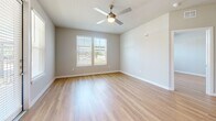Located at 18313 FM 1093 in Richmond, TX, this well-appointed single-story residence offers three bedrooms and three bathrooms with a thoughtfully designed layout. Light wood flooring flows seamlessly throughout the entire space, creating a warm, cohesive aesthetic.

The open-concept kitchen and living area serves as the heart of the home. The kitchen features a large central island with granite countertops and a built-in sink, two-tone cabinetry in white and slate gray, a subway tile backsplash, stainless steel appliances, and pendant lighting that adds a modern touch.

Each of the three bedrooms is bright and well-proportioned, benefiting from natural light provided by large windows with blinds. One bedroom includes a ceiling fan, adding comfort and functionality. The primary bedroom connects to a private en-suite bathroom and a dedicated walk-in closet outfitted with multi-level shelving and hanging rods.

The bathrooms maintain design consistency with granite-topped gray vanities and framed mirrors. The primary bath features a tiled shower, while secondary bathrooms include tub-shower combos. Clean neutral wall tones and wood-look flooring in the bathrooms tie the space together cohesively, creating a modern and functional living environment throughout.