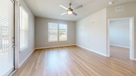 Located at 18313 FM 1093 in Richmond, TX, this well-appointed single-story residence offers three bedrooms and three bathrooms with a thoughtfully designed layout. Light wood flooring flows seamlessly throughout the entire space, creating a warm, cohesive aesthetic.

The open-concept kitchen and living area serves as the heart of the home. The kitchen features a large central island with granite countertops and a built-in sink, two-tone cabinetry in white and slate gray, a subway tile backsplash, stainless steel appliances, and pendant lighting that adds a modern touch.

Each of the three bedrooms is bright and well-proportioned, benefiting from natural light provided by large windows with blinds. One bedroom includes a ceiling fan, adding comfort and functionality. The primary bedroom connects to a private en-suite bathroom and a dedicated walk-in closet outfitted with multi-level shelving and hanging rods.

The bathrooms maintain design consistency with granite-topped gray vanities and framed mirrors. The primary bath features a tiled shower, while secondary bathrooms include tub-shower combos. Clean neutral wall tones and wood-look flooring in the bathrooms tie the space together cohesively, creating a modern and functional living environment throughout.