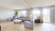 This well-appointed 3-bedroom, 2-bathroom residence in Waterloo, Ontario offers a thoughtfully designed layout across a single floor. The bright and airy living room features light hardwood flooring, large windows that flood the space with natural light, and direct access to one of two balconies, providing open views of the surrounding cityscape. The adjacent dining area continues the light, welcoming aesthetic with a ceiling fan overhead and a generous corner window that frames urban views, making it an ideal space for everyday meals or entertaining.

The generously sized primary bedroom is a serene retreat, complete with a ceiling fan, large windows overlooking the city, and seamless access to a private balcony. The two additional bedrooms are versatile and well-proportioned, with light hardwood floors and ample natural light. Both bathrooms are finished with classic white cabinetry, tile flooring, and mirrored storage, offering clean and functional design.

Connecting the rooms are well-proportioned hallways with crown moulding details and tile flooring. Throughout the residence, neutral tones and clean lines create a calm, cohesive ambiance. The two balconies extend the living space outdoors, offering elevated views of Waterloo's vibrant surroundings.