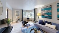 Located at 1969 SW Park Ave in Portland, Oregon, this one-bedroom, one-bathroom residence is designed to maximize both comfort and functionality. The living room serves as the heart of the home, featuring light hardwood-style flooring, a textured ceiling, and a prominent bay window that floods the space with natural light and offers views of the surrounding greenery. A large wall mirror enhances the sense of openness, while the layout comfortably accommodates both a seating and workspace area. The kitchen is efficiently designed with gray shaker-style cabinetry, white countertops, a gleaming iridescent tile backsplash, and stainless steel appliances including a refrigerator, range, and microwave. The bedroom is a calm retreat, finished with neutral tones, a ceiling fan, wall-mounted reading sconces, and a mirrored sliding closet door that adds depth to the room. A window with drapes allows for natural light while maintaining privacy. The bathroom features a clean, classic tub-shower combination with white tile surround. Two hallways connect the spaces efficiently throughout the single-floor layout, contributing to a smooth and intuitive flow. Overall, the residence offers a modern, practical living experience in a desirable Portland location.