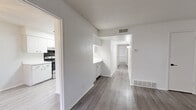 Located at 1600 Jones Dr in Arlington, TX, this single-floor, 3-bedroom, 2-bathroom unit offers a clean and functional layout with modern finishes throughout. The entryway opens into a spacious living area featuring light gray luxury vinyl plank flooring, crisp white walls, and a textured ceiling. A seamless opening connects the living space to an additional room, both finished with matching flooring for a cohesive feel. The kitchen is equipped with white cabinetry, light countertops, a stainless steel sink, and a black electric range, all accented by light LVP flooring and recessed overhead lighting. Each of the three bedrooms is well-proportioned, with the generously sized primary bedroom offering ample room for full furnishings. The bedrooms feature ceiling fans with light fixtures, windows with blinds for natural light and privacy, and sliding closet doors for convenient storage. Both bathrooms are finished in a clean, white aesthetic — one featuring a subway-tiled tub/shower combo with a grab bar, and the other with an enclosed tub/shower unit, white vanity, and overhead cabinet. The overall ambiance is bright, neutral, and move-in ready.