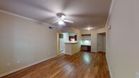 This single-story residence in Pearland, Texas offers a practical and comfortable layout across three bedrooms and two full bathrooms. The open living area is finished with warm wood-look flooring and crowned with crown molding, a ceiling fan, and recessed lighting, creating a clean, welcoming atmosphere. A large front-facing window allows natural light to fill the space, while a pass-through counter connects the living area seamlessly to the kitchen.

The kitchen is equipped with rich dark-wood cabinetry, light granite-style countertops, a double-basin sink, electric range, dishwasher, and refrigerator. Tile flooring runs throughout, and ample upper and lower cabinet storage adds practicality. Adjacent to the kitchen, a built-in desk with open shelving provides a convenient workspace or study nook.

The bedrooms feature the same warm wood-look flooring, ceiling fans, and windows with blinds that invite natural light. Both bathrooms include tub-shower combinations with tile surrounds, tile flooring, and dark-wood vanities with granite-style countertops. The second bathroom also features a wall-mounted storage cabinet for added functionality. Throughout, neutral tones and consistent finishes create a cohesive, move-in-ready environment.