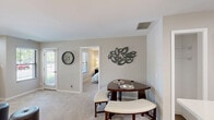 Located at 201 Remington Cir in Schaumburg, IL, this well-appointed one-bedroom, one-bathroom residence offers a thoughtfully designed single-floor layout with a warm and welcoming ambiance throughout. Neutral-toned walls, plush carpeting, and an abundance of natural light from multiple windows give the space a bright, comfortable feel.

The kitchen stands out with crisp white shaker cabinets, white quartz countertops, stainless steel appliances including a refrigerator, electric range, and microwave, plus wood-look flooring that adds a touch of warmth. A stainless steel sink and clean sightlines make this an efficient and stylish workspace.

The living room offers generous floor space with carpet, multiple windows with blinds, and direct access to the outdoors through a full-length glass door, allowing plenty of natural light to flow in. A dedicated dining area sits adjacent, making the space functional for everyday living.

The bedroom is comfortably sized, featuring carpet, a window with outdoor views, and convenient direct access to both the walk-in closet and the bathroom. The bathroom is finished with white shaker cabinetry, a wide vanity with a large mirror, a bright vanity light bar, white subway tile, and light wood-look tile flooring. The overall design throughout is clean, modern, and move-in ready.