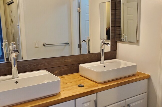 Renovated Bathroom with double vanities and cabinets, and hardwood floor - 502 Granville Ct