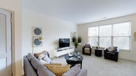 Located in Columbus, Ohio's 43206 zip code, this two-story residence at 345 East Deshler Avenue combines modern design with comfortable, functional living. The living area serves as the heart of the home, featuring neutral-toned walls and plush carpeting that create a warm, welcoming atmosphere. Large windows allow abundant natural light to fill the room, enhancing the open and airy feel of the space. The layout accommodates generous seating arrangements and a dedicated media area, making it well-suited for both relaxing and entertaining. The clean lines and understated color palette throughout the living space reflect a contemporary design sensibility, with subtle decorative touches that add character without overwhelming the room. Spreading across two floors, the residence offers a functional separation of living and private spaces, providing both openness on the main level and a sense of retreat on the upper floor. The overall ambiance of the home is calm and cohesive, with consistent finishes and a neutral design language that offers a versatile backdrop for a variety of interior styles. Its location in Columbus adds convenient access to the surrounding neighborhood's amenities.