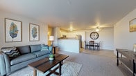 Located at 227 Seippel Blvd in Beaver Dam, Wisconsin, this single-floor residence offers a thoughtfully designed layout with a clean, contemporary aesthetic throughout. The open-concept living, dining, and kitchen area forms the heart of the home, with carpet underfoot in the living space transitioning to wood-look luxury vinyl flooring in the kitchen and dining areas. A ceiling fan overhead and access to a patio with outdoor views add comfort and functionality to this central gathering space.

The kitchen is well-equipped with stainless steel appliances, including a refrigerator, range, and over-the-range microwave. White cabinetry with ample storage lines the walls, complemented by granite-style countertops and a stainless steel sink. The adjacent dining area provides a comfortable space for meals.

The bedrooms are carpeted and generously sized, with windows allowing natural light to filter in. The primary bedroom features direct access to its own bathroom and additional doorways suggesting a walk-in closet or en-suite configuration. The bathroom showcases white cabinetry, granite-style countertops, and wood-look tile flooring.

A dedicated laundry room with a full-size washer and dryer, wire shelving, and hardwood-style flooring adds everyday convenience to this well-rounded residence.
