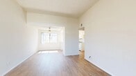 Located at 1350 Milburn Ave in Redlands, CA, this single-story 2-bedroom, 1-bathroom residence offers a well-organized and efficient layout. The living area features light wood-look flooring and flows openly into a second living or dining space, defined by a framed archway overhead and a ceiling fan. Natural light pours in through a front-facing window, creating a bright and airy atmosphere throughout. The kitchen is positioned just off the main living area and is outfitted with white cabinetry, a gas range with overhead microwave, a double-basin sink, and light stone-look countertops. A window above the sink brings in additional natural light. The primary bedroom is a comfortable, generously proportioned room with plush carpeting, a large sliding glass door opening to an outdoor patio with tree-lined views, and ample closet space. The second bedroom also features carpet flooring, a sliding closet, and a window with natural light. The bathroom is clean and functional, featuring a tub-shower combination, white vanity with granite-style countertop, and wood-look flooring. A hallway connects the main living spaces to the bedrooms and bathroom, maintaining a logical and convenient flow throughout the home.
