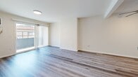 This 520 square foot apartment in Los Angeles offers a well-designed living space with modern amenities. The single-story layout comprises one bedroom, one bathroom, and an open-concept kitchen and living area. The primary bedroom, measuring 180 square feet, provides ample space for a comfortable retreat.

Throughout the apartment, light-toned wood-look flooring creates a cohesive and contemporary aesthetic. Large windows in the living area and bedroom invite natural light, enhancing the sense of spaciousness. The living room features sliding glass doors that open to a small outdoor area, extending the living space.

The kitchen boasts crisp white cabinetry, contrasting dark countertops, and stainless steel appliances, including a refrigerator and oven. Its galley-style layout maximizes efficiency in the compact space.

The bathroom is equipped with a shower/tub combination, built-in shelving, and modern fixtures. The clean, white design contributes to a fresh and hygienic atmosphere.

Ceiling-mounted light fixtures provide even illumination throughout the apartment. An air conditioning unit in the living area ensures comfort during warm weather. The neutral color palette of whites and light grays creates a blank canvas for personalization.

This apartment's thoughtful design makes efficient use of its 520 square feet, offering a comfortable and stylish living space in the heart of Los Angeles.