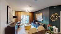 Located at 1025 Preston Rd in Plano, TX, this thoughtfully designed single-floor residence blends contemporary aesthetics with comfortable living. The living area serves as the centerpiece of the home, showcasing a deep teal accent wall adorned with large-scale artwork, a modern sputnik chandelier, and rich amber drapery that frames a sliding glass door opening to a private outdoor balcony. The space is anchored by plush seating, a sculptural gold drum coffee table, and warm hardwood-style flooring.

The kitchen is both functional and elegant, featuring dark espresso cabinetry with glass-front uppers, a white quartz countertop island with bar seating, a herringbone tile backsplash, and a full suite of stainless steel appliances. The layout flows seamlessly into the dining and entry areas.

The primary bedroom offers a serene retreat with a deep teal accent wall, gallery-style framed artwork, plush carpeting, and natural light filtered through striped drapery. A ceiling fan adds practical comfort. A secondary bedroom provides a cozy, design-forward space with bold dark walls and layered abstract artwork.

Two well-appointed bathrooms complete the residence. One features a quartz vanity with dark cabinetry and a tiled tub-shower combination, while the other offers a wide-format mirror, illuminated vanity lighting, and an open storage vanity with quartz countertops.