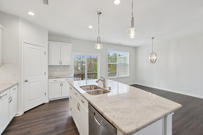 Upgrade Package Kitchen and dining area with hard-surface vinyl plank flooring - Avalon Townhomes Brier Creek