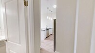 Located at 1465 Lawrence Ave W in Toronto's Lawrence Heights neighbourhood, this well-appointed one-bedroom unit offers a thoughtfully designed layout with modern finishes throughout. The open-concept kitchen is a standout feature, showcasing tall white shaker cabinetry that extends to the ceiling, rich dark stone countertops, and a light blue subway tile backsplash. A central island with a built-in sink provides additional prep space and casual dining potential, while pendant lighting above adds a contemporary touch. Stainless steel appliances, including a full-size refrigerator, electric range, and built-in microwave, complete the kitchen's polished look. Light hardwood-style flooring runs seamlessly throughout the space, lending warmth and continuity. The bedroom is a calm, neutral retreat with soft grey walls and a large window that welcomes natural light and outdoor views. A baseboard heater beneath the window ensures year-round comfort. The overall aesthetic is clean and modern, with a bright, airy ambiance created by the white palette and natural light. This unit is an excellent fit for those seeking a functional, stylish home in a convenient Toronto location.