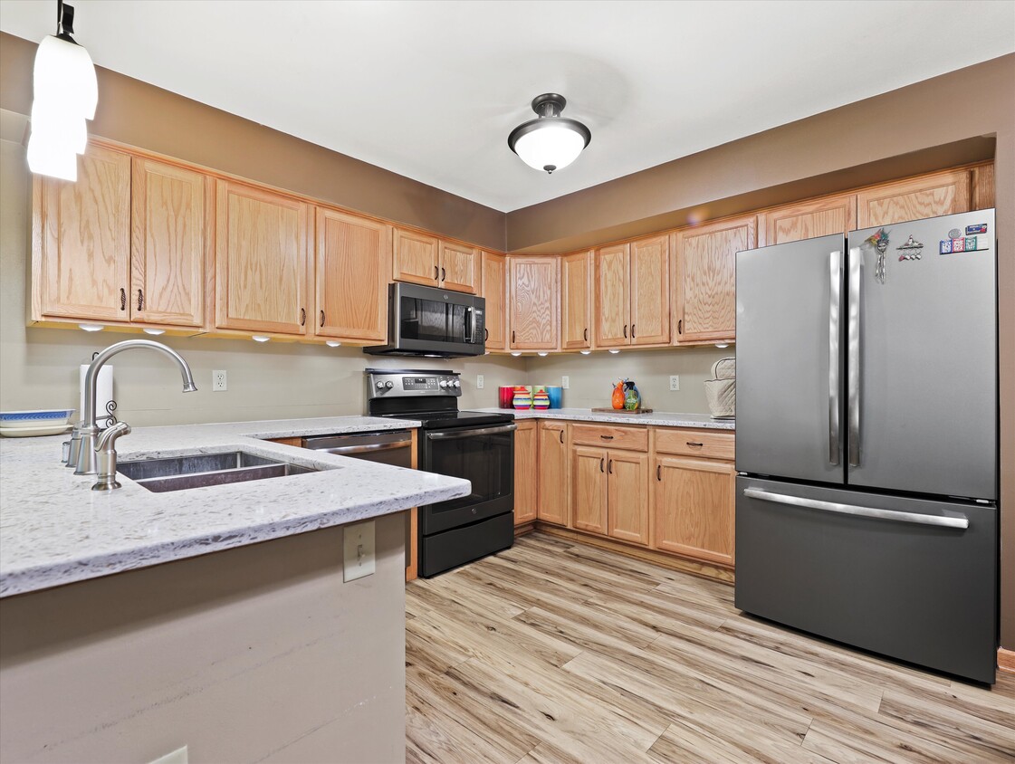 Kitchen with GE stainless steel appliances. - 2112 Woodburn Rd