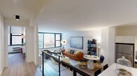 Located in Chicago's vibrant Streeterville neighborhood, this well-appointed residence at 26 E Pearson St offers a thoughtfully designed single-floor layout with a clean, contemporary aesthetic throughout. Light wood-tone flooring flows seamlessly across the open-concept living and dining areas, creating a cohesive and welcoming atmosphere. Large floor-to-ceiling windows flood the living room with natural light while framing views of the surrounding Chicago cityscape. The living area comfortably accommodates both a seating arrangement and a dining space, ideal for everyday living and entertaining. A split-level design element with a sleek metal railing adds architectural interest and visual depth to the main living zone. The kitchen is outfitted with white cabinetry, a tile backsplash, white quartz countertops, stainless steel appliances, and a central island with bar seating — a highly functional space with a polished finish. The bedroom features oversized windows with roller shades, a built-in closet with sliding doors, and a serene, airy ambiance. The bathroom presents a refined look with a backlit oval mirror, an undermount sink with quartz countertops, and warm wood-toned cabinetry. Additional storage is visible throughout, including a walk-in closet area accessible from the kitchen. The overall design balances modern minimalism with comfortable livability.