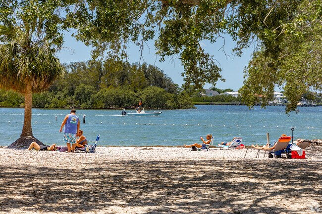 Sun warms the beach as boats pass along the Anclote River near Holiday.