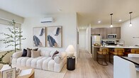 Located in Vancouver, Washington, this thoughtfully designed three-bedroom, two-bathroom single-floor residence offers a well-utilized layout with modern finishes throughout. Light wood-style flooring flows consistently across the home, creating a cohesive and airy aesthetic complemented by neutral wall tones and abundant natural light.

The living room serves as the heart of the home, featuring a wall-mounted mini-split climate system, large windows with outdoor views, and a welcoming atmosphere ideal for relaxing or entertaining. Adjacent to it, the galley-style kitchen is efficiently organized with warm taupe cabinetry, white quartz countertops, a stainless steel refrigerator, and a double sink — maximizing every inch of available space.

The primary bedroom is a comfortable retreat with a sizable window that invites natural light, while the two additional bedrooms offer flexibility for guests, a home office, or other needs — one featuring sliding closet doors and another with open access to the hallway.

Both bathrooms are finished with wood-toned cabinetry and white countertops. The primary bath includes a stylish vanity with ample drawer storage and a large mirror, while the second bath features a full shower-tub combination.

A dedicated laundry room with a full-size side-by-side washer and dryer rounds out the functional amenities of this well-appointed home.