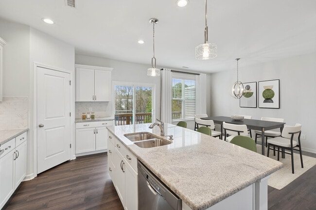Upgrade Package Kitchen and dining area with hard-surface vinyl plank flooring - Avalon Townhomes Brier Creek