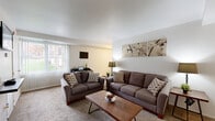 Located at 2500 Knights Rd in Bensalem, PA, this two-bedroom, one-bathroom residence is thoughtfully laid out across a single floor. The living room is a welcoming, carpeted space filled with natural light from large windows with vertical blinds, offering a comfortable and open atmosphere. It flows seamlessly into a dedicated dining area, making the layout practical for everyday living and entertaining. The kitchen features warm wood-toned cabinetry and standard appliances, providing a functional space for meal preparation. The primary bedroom is a generously sized, carpeted retreat with a large window dressed in vertical blinds, offering ample natural light. It includes closet storage and room for full bedroom furnishings. The second bedroom is bright and cozy, also carpeted, with its own window and closet access. The bathroom is well-appointed with large-format tile surround encasing a full soaking tub and shower combination, complemented by a clean white vanity. Throughout the home, four closets provide exceptional storage capacity. A hallway connects the rooms efficiently, and a utility room adds additional functionality. The neutral color palette and carpet flooring throughout create a cohesive, move-in-ready environment.