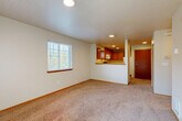 Located at 620 Lincoln St in Bellingham, WA, this one-bedroom, one-bathroom unit offers a practical and comfortable layout across a single floor. The open-concept living and dining area is carpeted and bathed in natural light from multiple windows fitted with blinds, creating a bright and welcoming atmosphere. A pass-through breakfast bar connects the living area to the kitchen, which features warm oak cabinetry, tile flooring, generous counter space, a full appliance suite including a dishwasher, electric range, and microwave, as well as a window that brings in additional natural light. The bedroom is a well-proportioned, carpeted retreat with a window overlooking the outdoors and access to ample closet space. The unit is notably well-equipped with five closets distributed throughout, offering excellent storage. The full bathroom includes a single-sink vanity with oak cabinetry, a shower-tub combination, and tile flooring. A dedicated entrance, hallway, and private balcony round out the floor plan. The unit's neutral color palette, consistent warm wood accents, and carpet throughout the main living spaces contribute to a cohesive and comfortable ambiance.