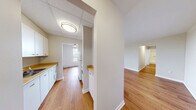 Located at 156-158 Fitch St in Welland, Ontario, this 2-bedroom, 1-bathroom unit offers a practical and well-organized single-floor layout. Warm hardwood-style flooring flows consistently throughout the space, lending a cohesive and inviting feel to every room.

The living room is a bright, open area bathed in natural light from large windows, with baseboard heating running along the walls. The kitchen is equipped with white cabinetry, tile backsplash, an electric coil range, and countertop space — providing all the essentials in a compact, efficient layout.

Both bedrooms feature the same warm flooring and are served by natural light through windows with outdoor views of the surrounding greenery and neighbourhood. The primary bedroom includes a ceiling fan and baseboard heating, while the second bedroom offers a large built-in sliding door closet, providing generous storage. The full bathroom is fitted with a tiled tub-shower combination featuring chrome fixtures and a grab bar.

A connecting hallway ties the rooms together for smooth circulation throughout. From the windows, residents can enjoy views of the landscaped grounds and surrounding area. The unit's clean, neutral palette and consistent finishes create a bright, move-in-ready environment suited for comfortable everyday living.