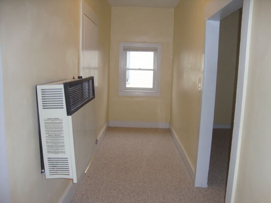 Hall. 2 bedrooms and gas heater on left. Living Room on right. - 130 N Shenango St
